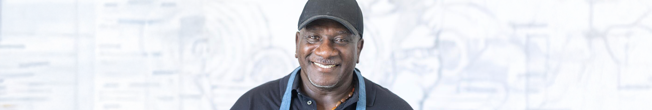 Image of Gary Tyler with a black hat and white background